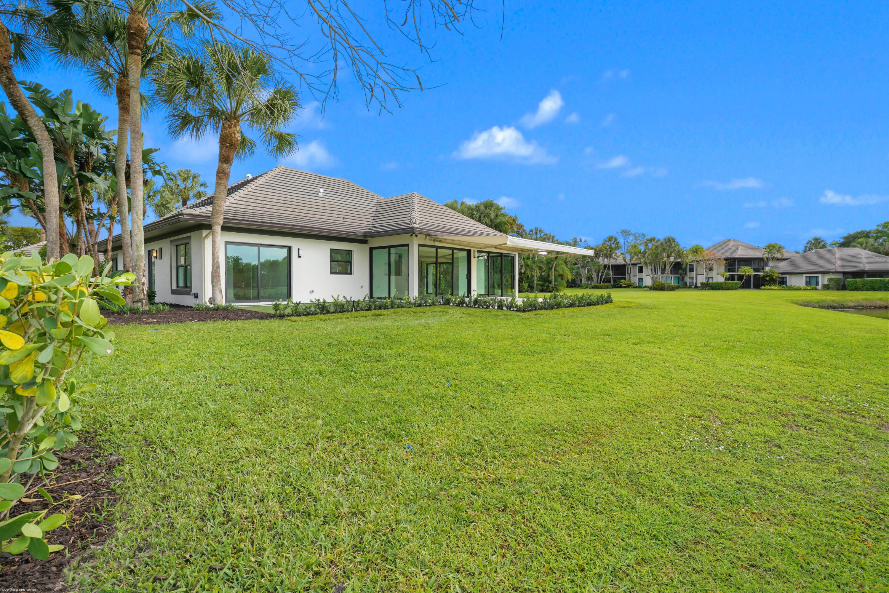 13254 Polo Club Road, Unit C101 Wellington, FL 33414 - Photo 6 of 71 a front view of a house with a garden