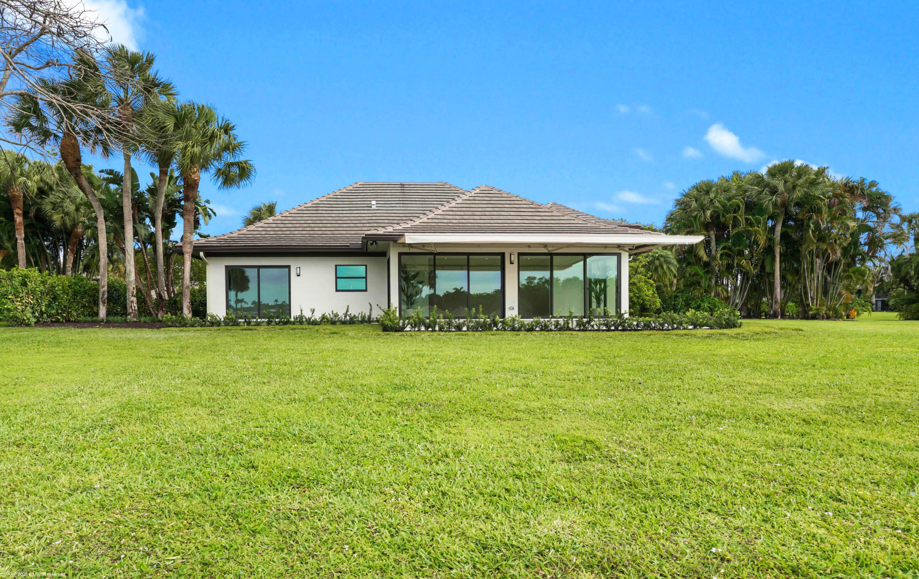 13254 Polo Club Road, Unit C101 Wellington, FL 33414 - Photo 7 of 71 a front view of a house with a garden