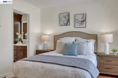 a bedroom with a bed and painting on the wall