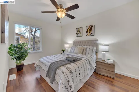 a bedroom with bed and a chandelier