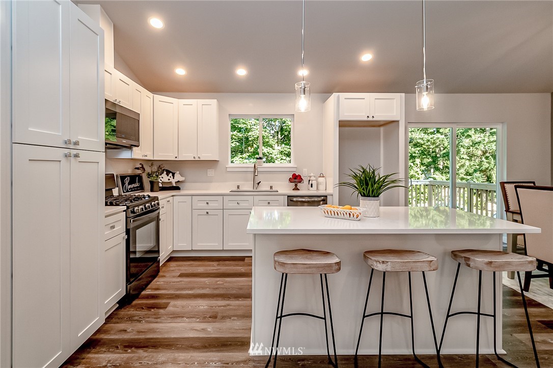 17702 30th Drive Southeast Bothell, WA 98012 - Photo 2 of 17 a kitchen with white cabinets and white appliances