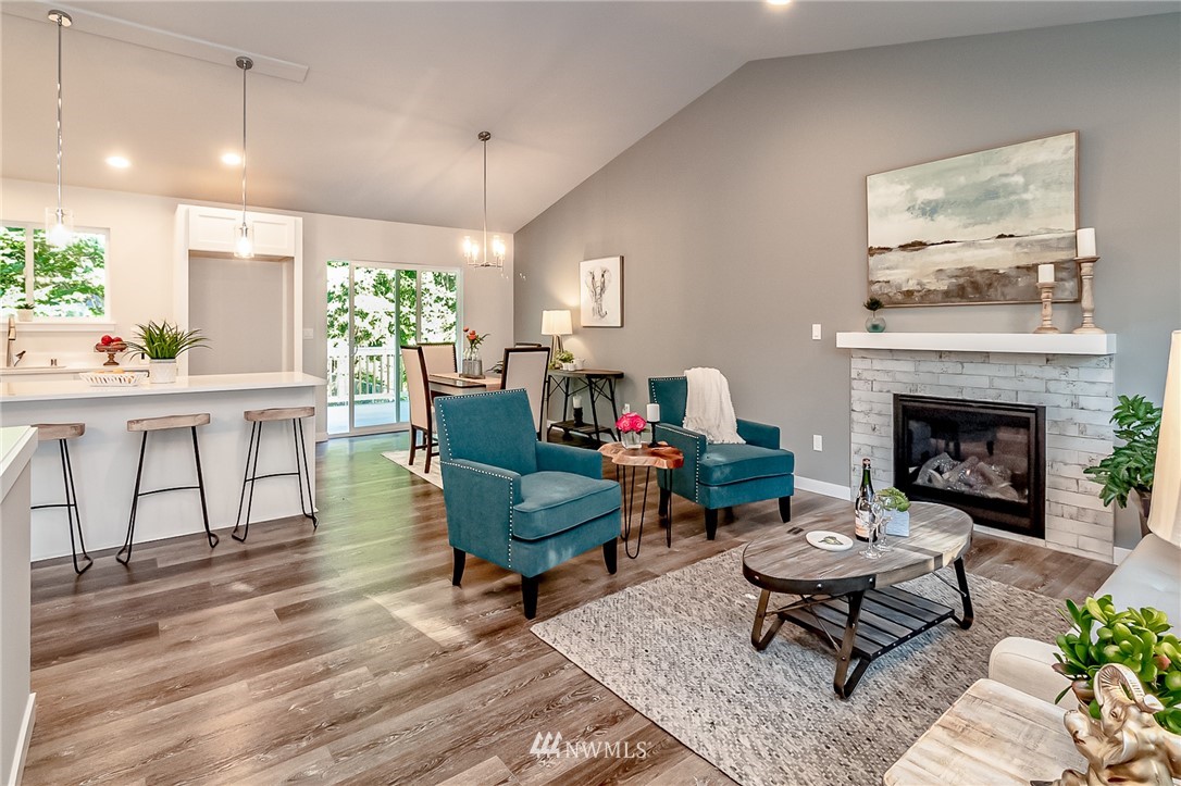 17702 30th Drive Southeast Bothell, WA 98012 - Photo 3 of 17 a living room with furniture a rug and a fireplace