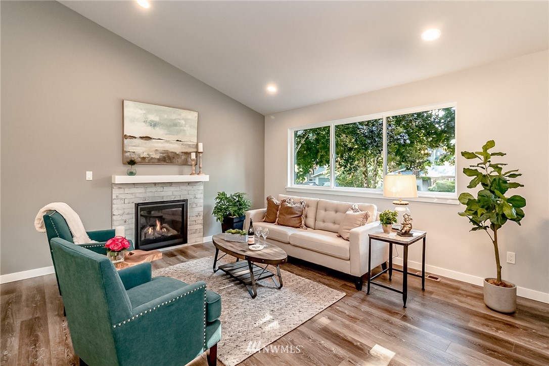17702 30th Drive Southeast Bothell, WA 98012 - Photo 5 of 17 a living room with furniture a potted plant and a fireplace