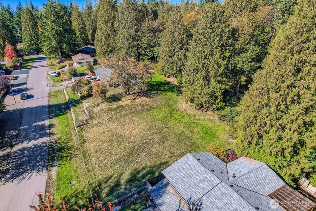an aerial view of a house with a yard basket ball court and outdoor seating