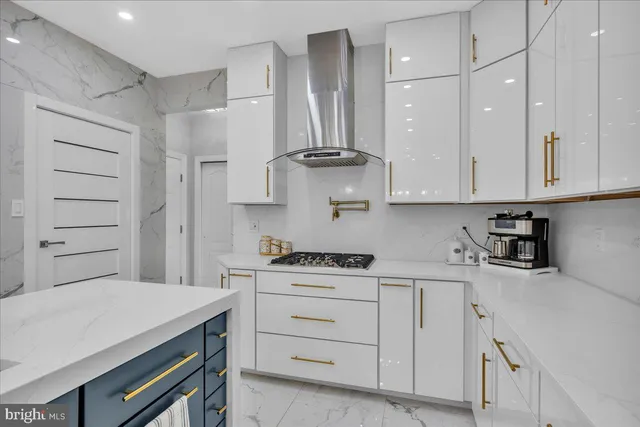 a kitchen with white cabinets stainless steel appliances and sink