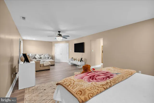 a bedroom with a bed and flat screen tv