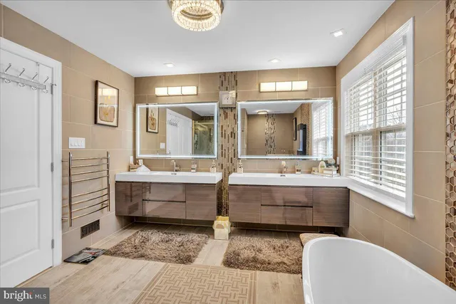 a bathroom with sink mirror and bathtub