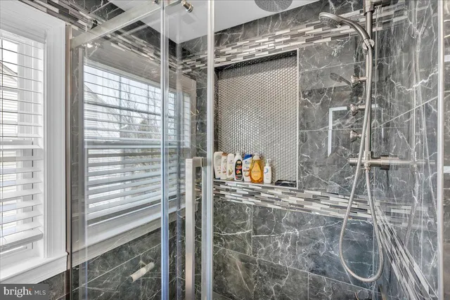 a bathroom with a shower and a mirror