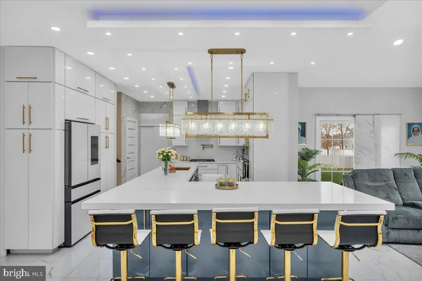 a kitchen with a table chairs refrigerator and microwave