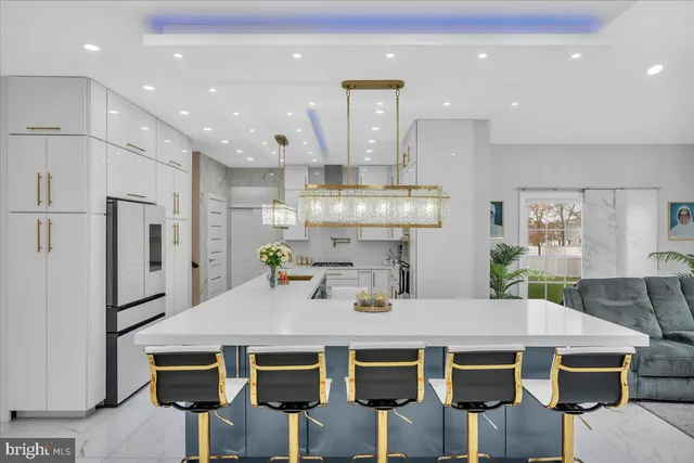 a kitchen with a table chairs refrigerator and microwave