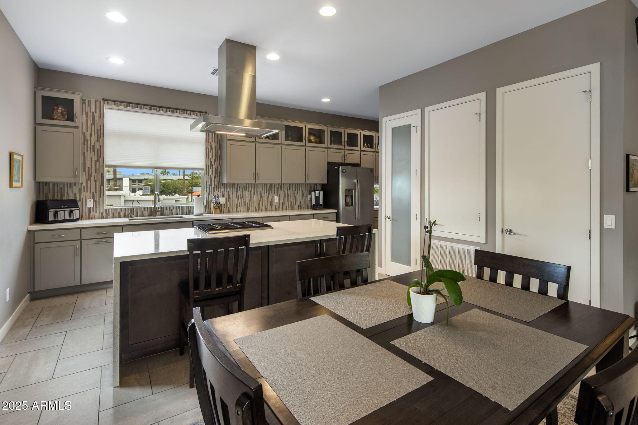 325 East Coronado Road, Unit 19 Phoenix, AZ 85004 - Photo 4 of 25 a kitchen with a stove a sink a dining table and chairs