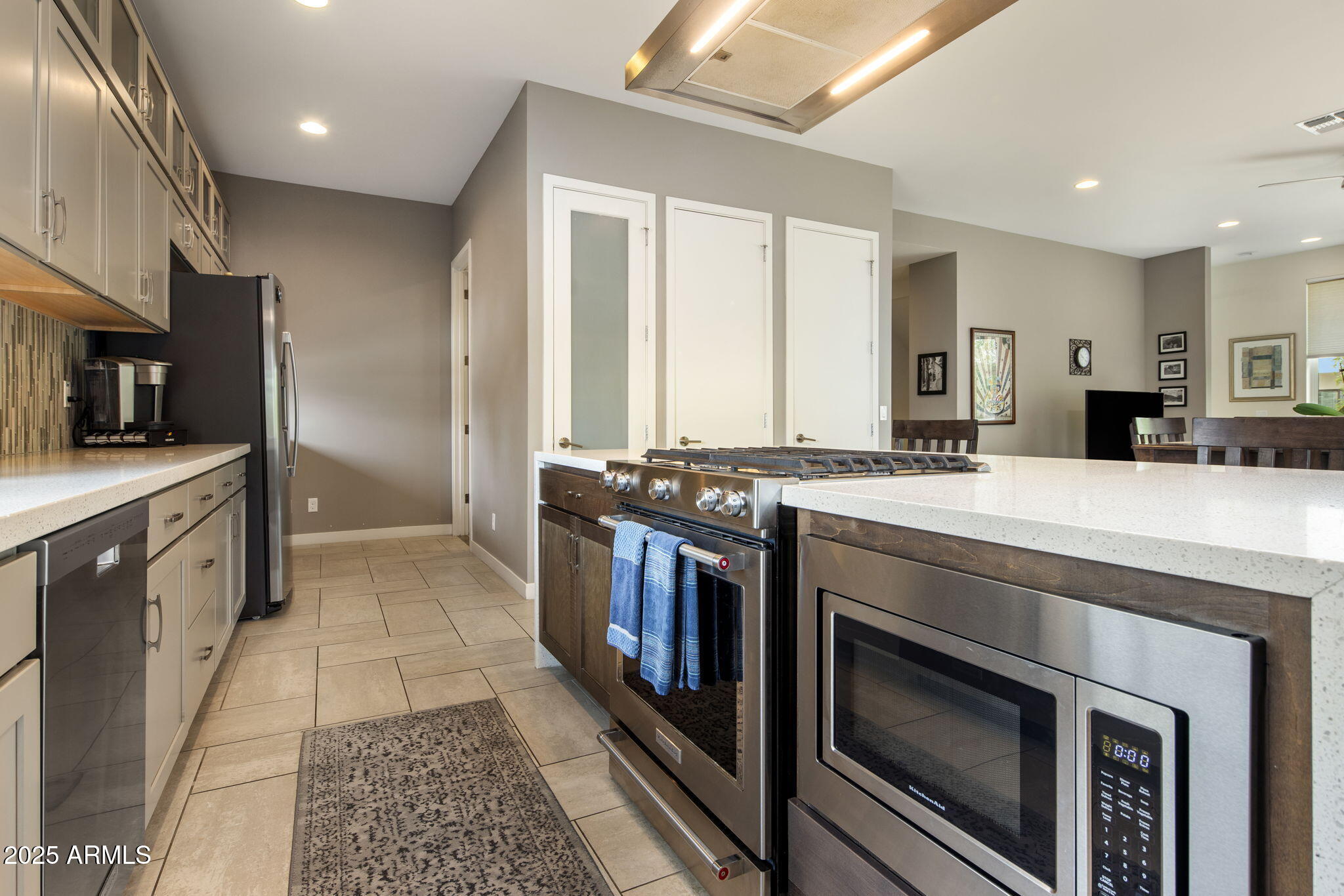 325 East Coronado Road, Unit 19 Phoenix, AZ 85004 - Photo 5 of 25 a kitchen with stainless steel appliances kitchen island granite countertop a stove a sink and a microwave
