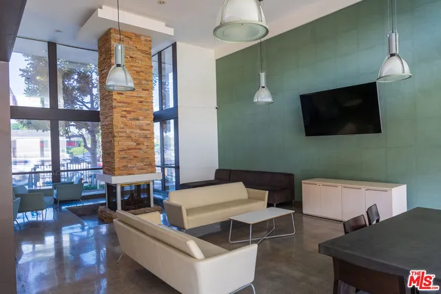 a dining room with furniture and a floor to ceiling window