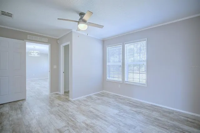 a view of an empty room and wooden floor