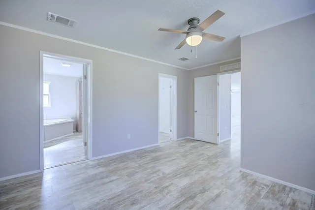 a bathroom with a sink double vanity granite tub and a mirror