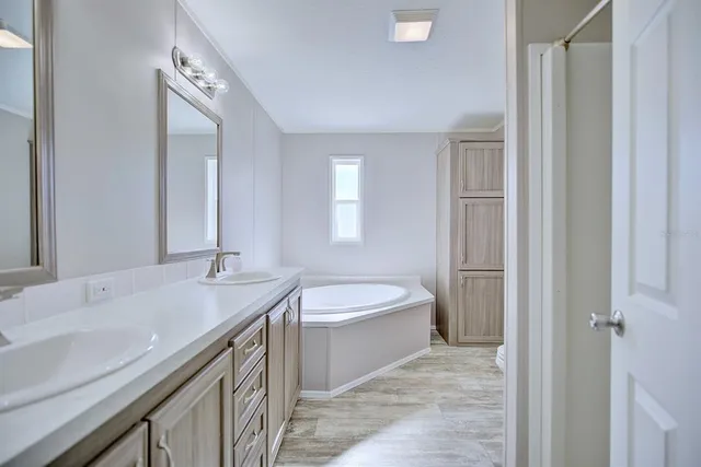 a bathroom with a double vanity sink and a mirror