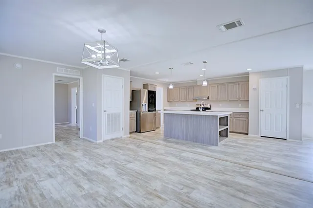 a view of kitchen with granite countertop stainless steel appliances cabinets a sink and a counter top space