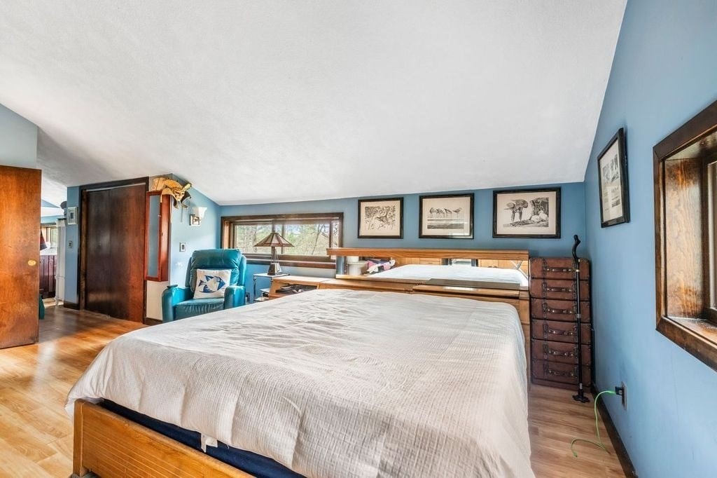 54 Acropolis Road Lowell, MA 01854 - Photo 14 of 35 a spacious bedroom with a bed and a dresser with mirror
