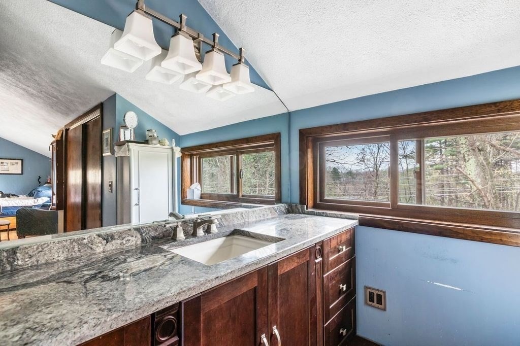 54 Acropolis Road Lowell, MA 01854 - Photo 15 of 35 a bathroom with a granite countertop sink and a large window