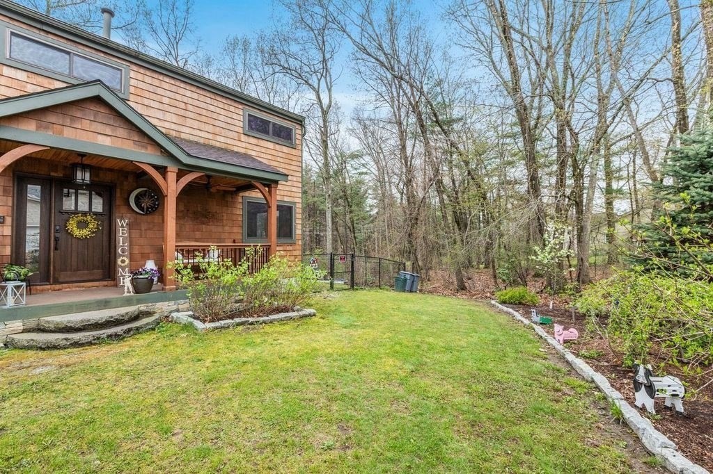 54 Acropolis Road Lowell, MA 01854 - Photo 3 of 35 a front view of a house with garden