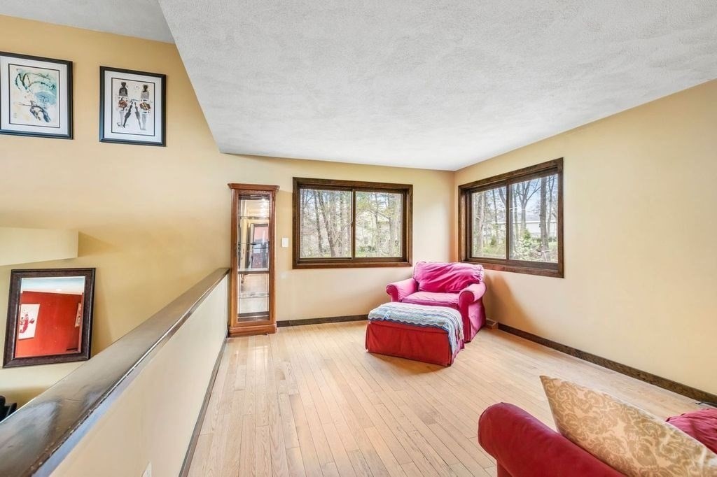 54 Acropolis Road Lowell, MA 01854 - Photo 10 of 35 a bedroom with a bed and wooden floor