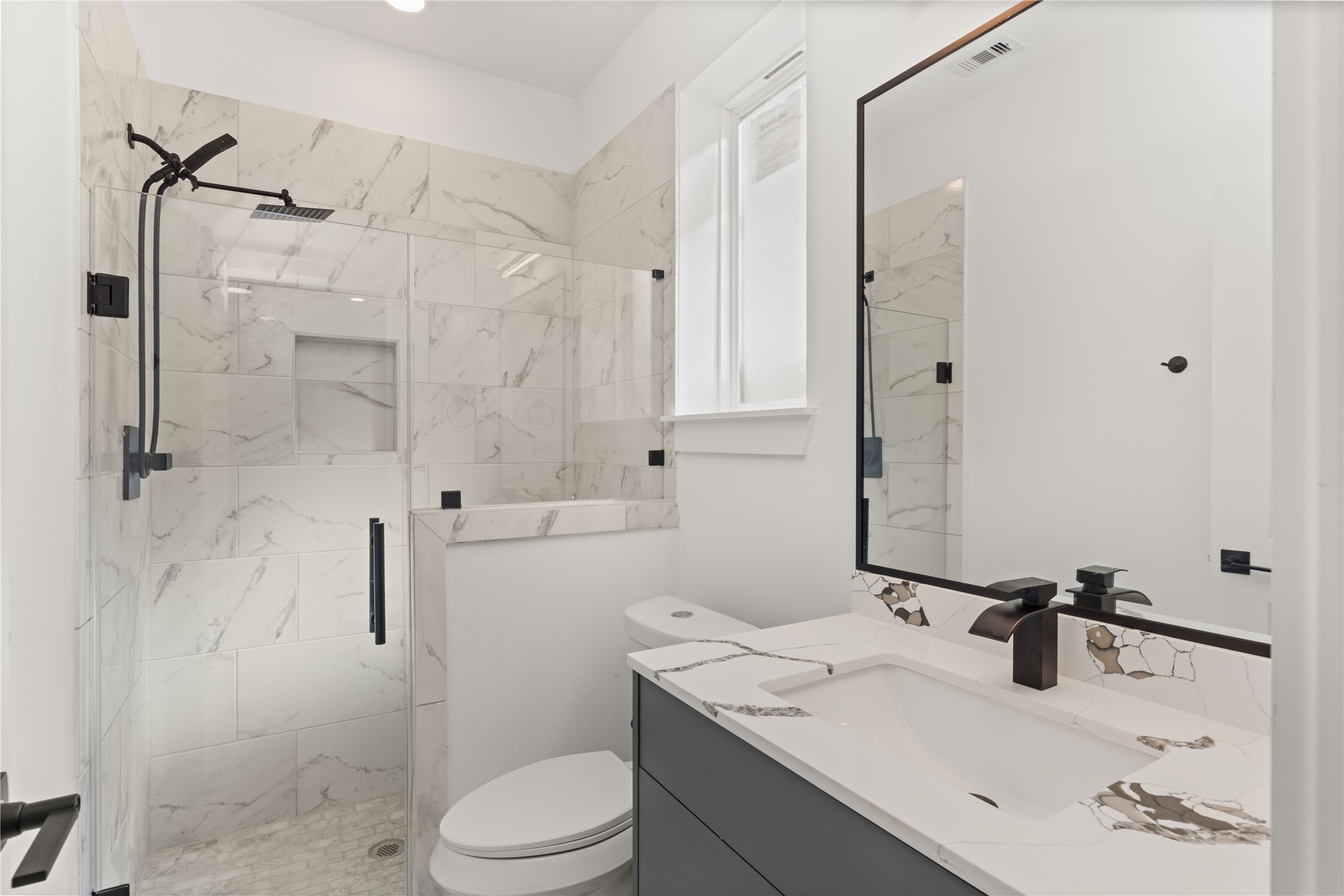 2709 Dennis Street Houston, TX 77004 - Photo 2 of 20 a bathroom with a sink toilet and shower