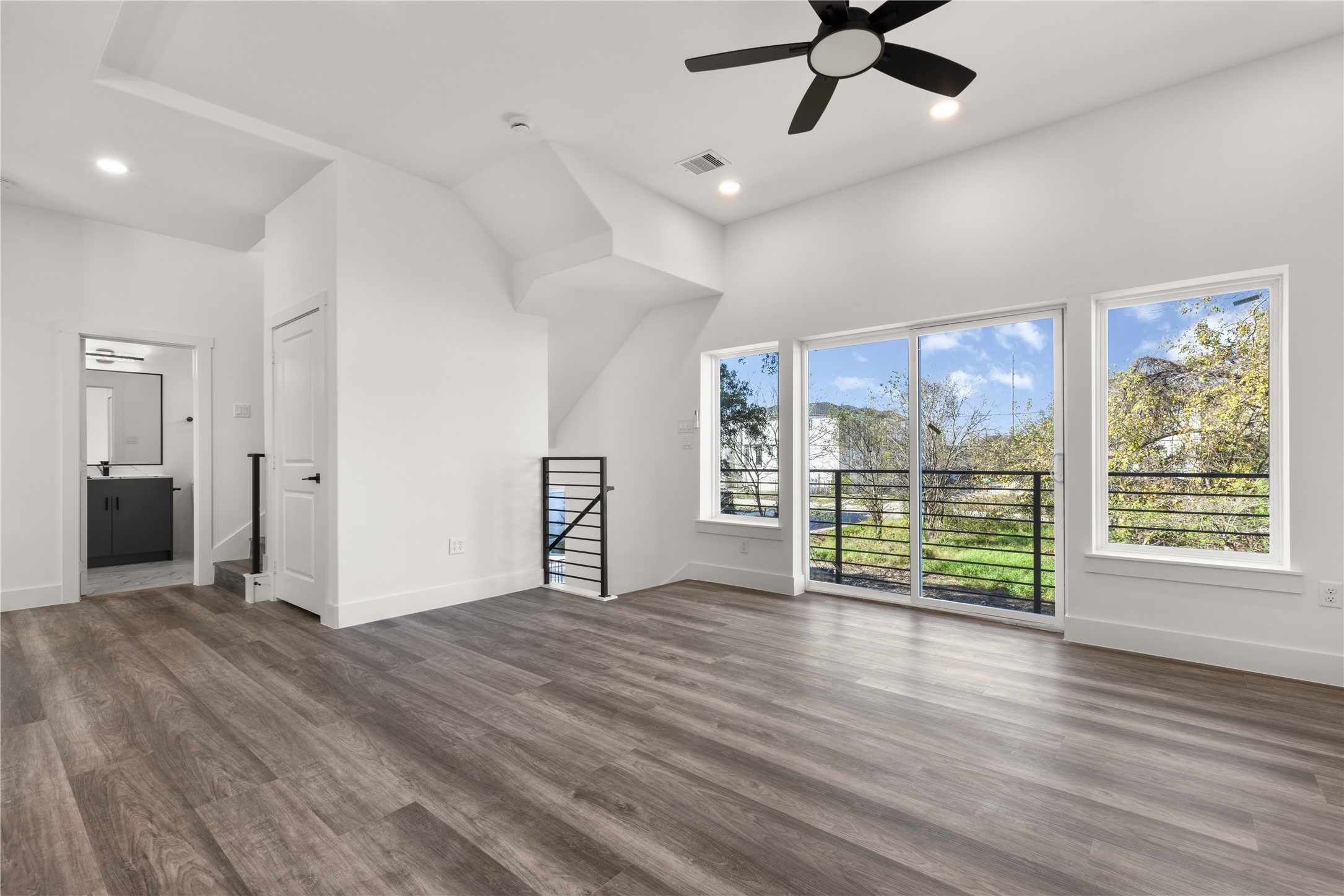 2709 Dennis Street Houston, TX 77004 - Photo 4 of 20 a view of an empty room with a window and wooden floor