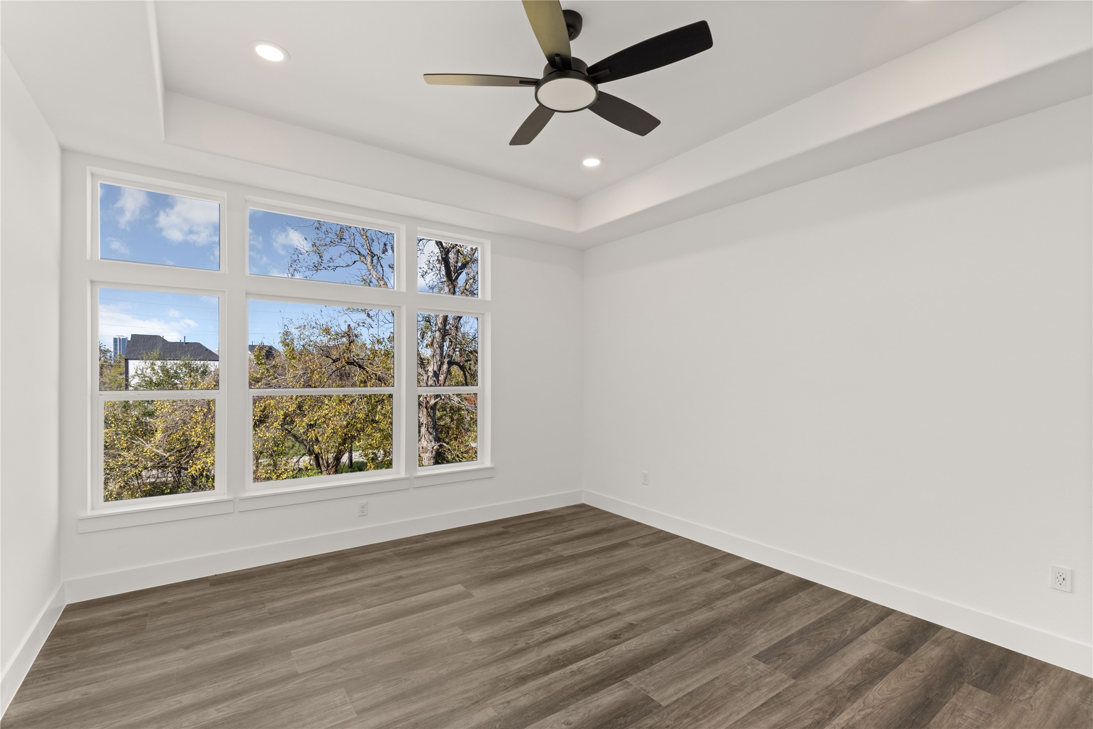 2709 Dennis Street Houston, TX 77004 - Photo 7 of 20 an empty room with wooden floor and windows