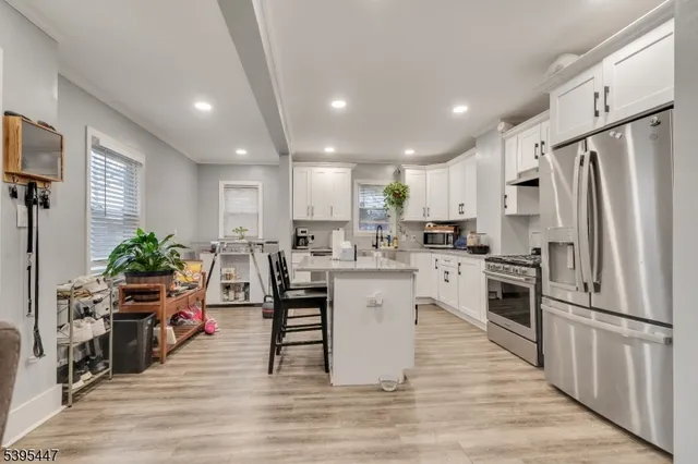 a kitchen with white cabinets and stainless steel appliances