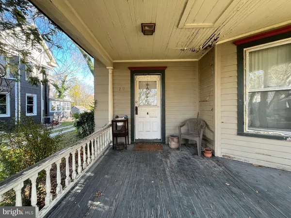 a view of a porch with wooden floor and furniture