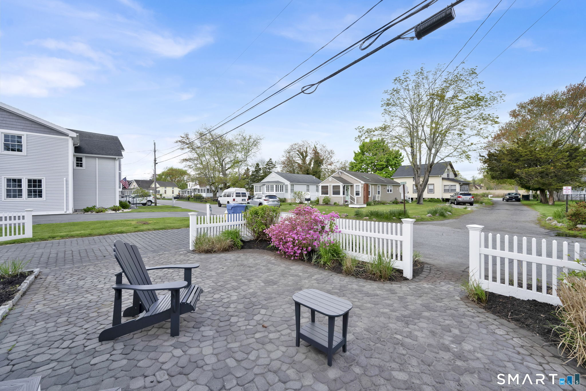 96 Chalker Beach Road Old Saybrook, CT 06475 - Photo 2 of 33 a view of a chair and table in backyard of the house