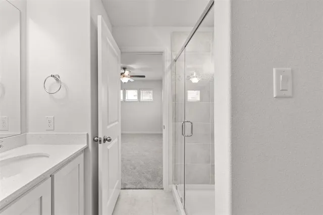 a bathroom with a shower and a sink