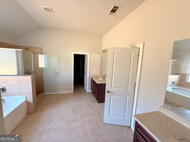 a view of kitchen with furniture and refrigerator