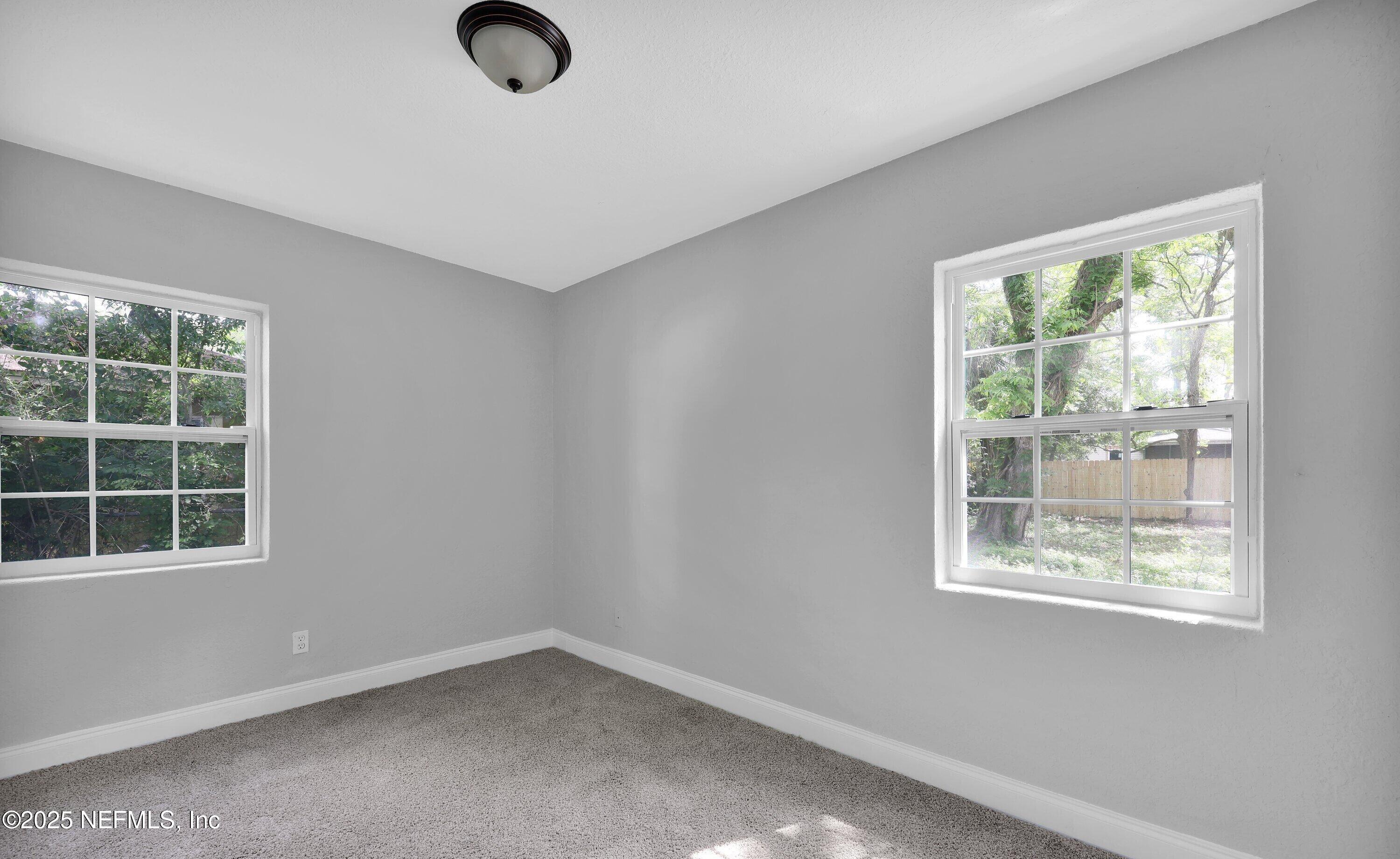 3653 Freeman Road Jacksonville, FL 32207 - Photo 4 of 27 an empty room with windows