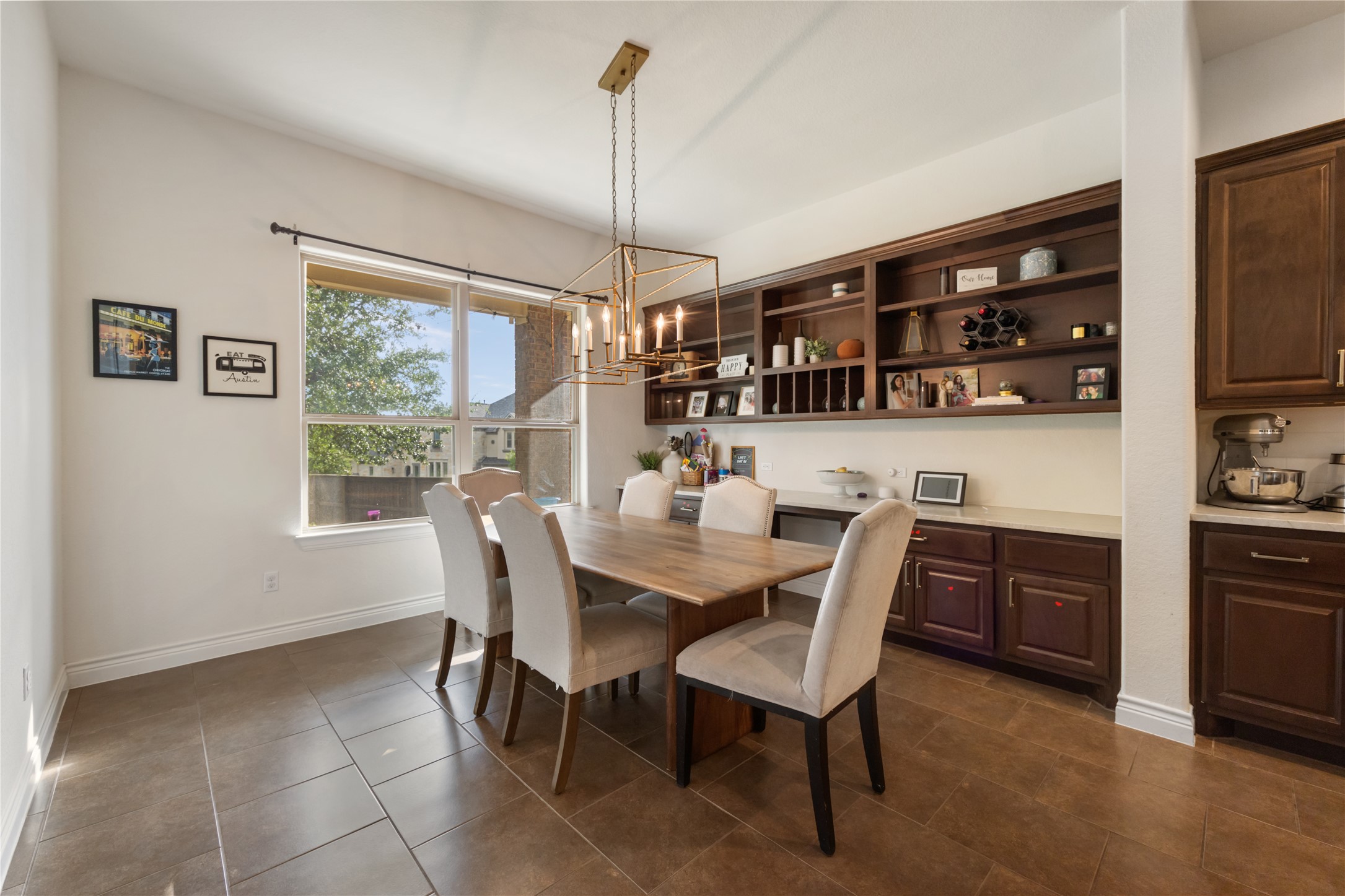 415 Bitterroot Lane Austin, TX 78737 - Photo 5 of 25 A warm and inviting dining space, featuring built-in cabinetry and abundant natural light.