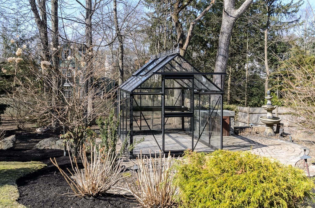 32 Sunset Road Wellesley, MA 02482 - Photo 22 of 23 a backyard of a house with table and chairs