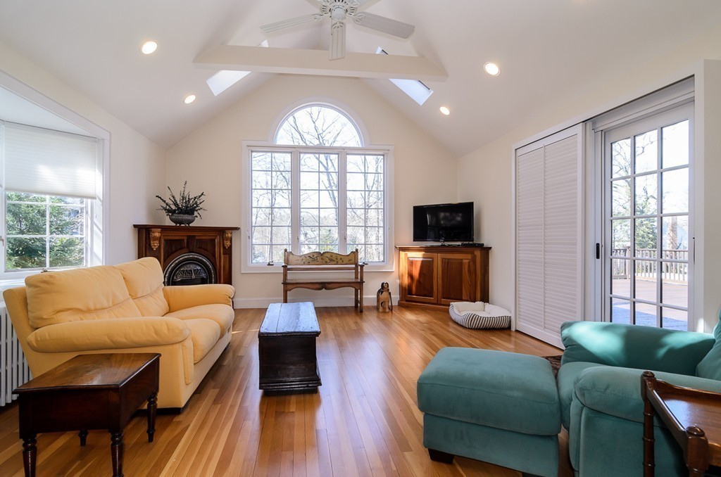 32 Sunset Road Wellesley, MA 02482 - Photo 6 of 23 a living room with furniture a fireplace and a flat screen tv