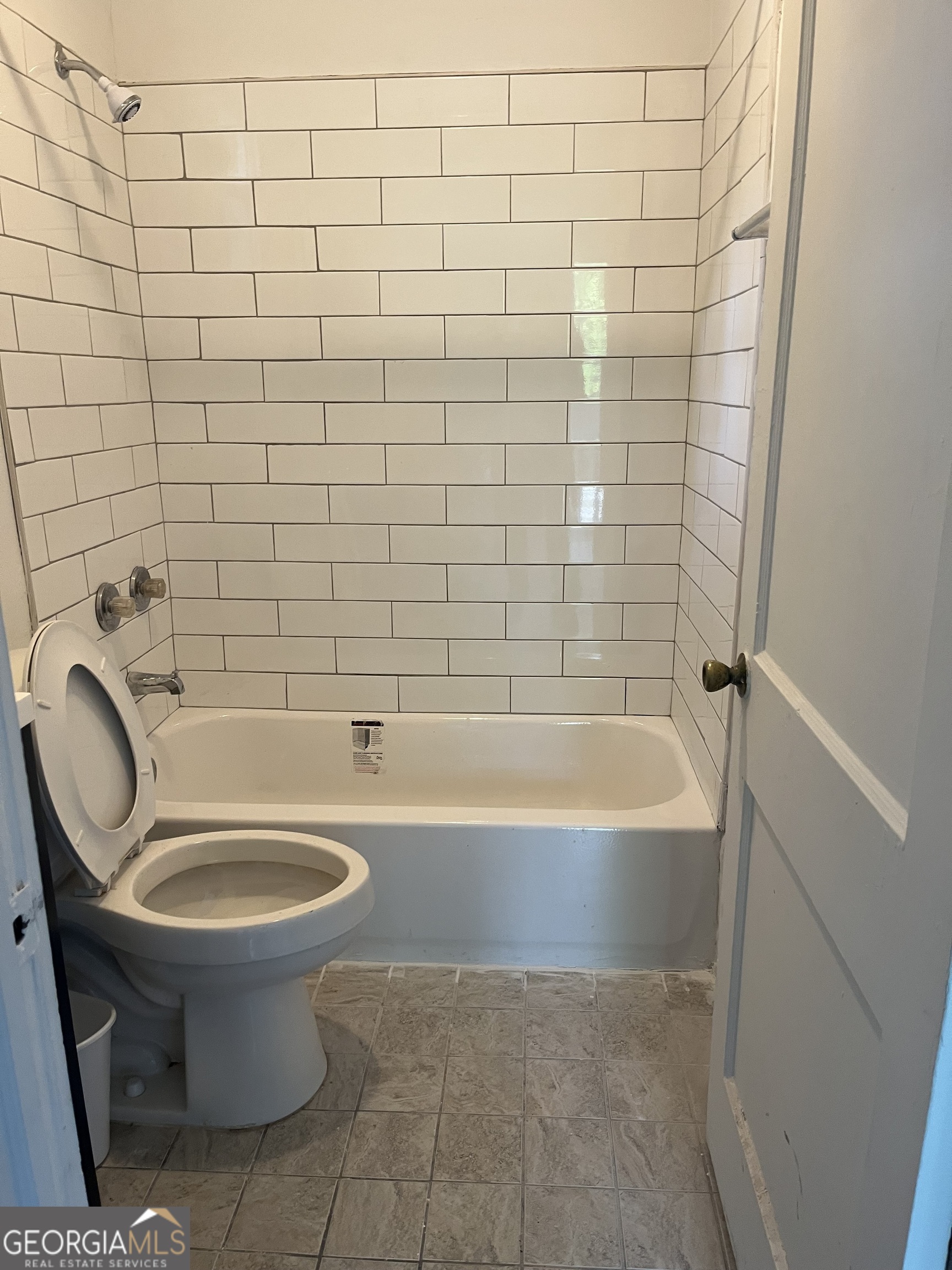 a bathroom with a sink a toilet and bathtub
