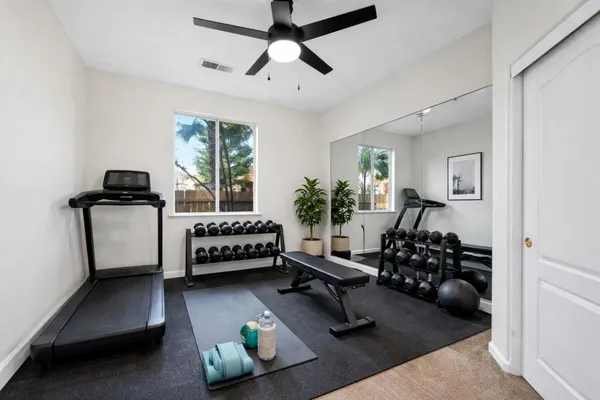 a kitchen with granite countertop white cabinets and stainless steel appliances