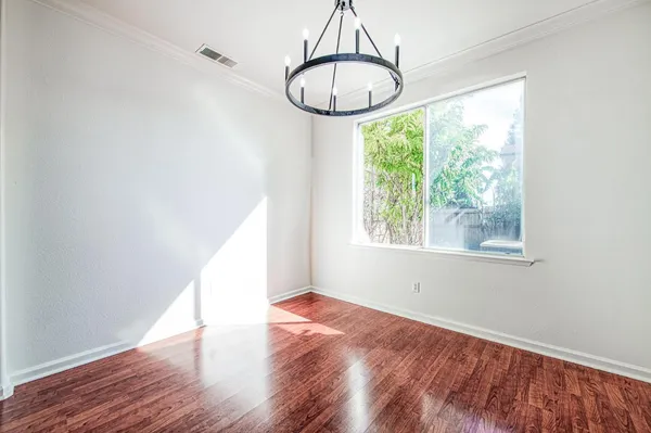 a spacious bedroom with a bed and closet with wooden floor