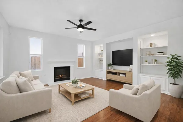 a view of empty room with wooden floor and entryway