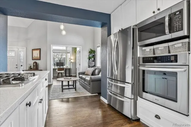 a kitchen with stainless steel appliances granite countertop a refrigerator stove and sink