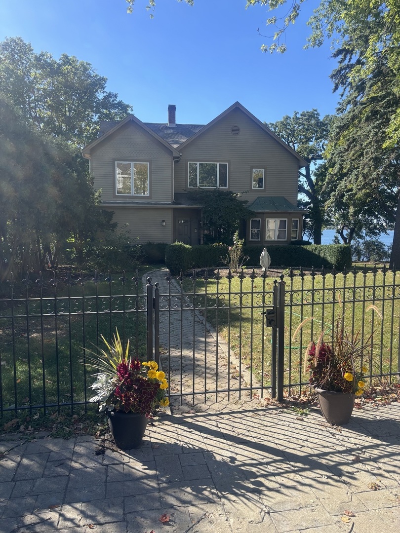 a front view of a house with a garden