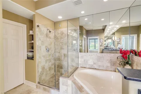 a bathroom with a bathtub and a shower