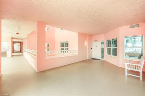 a very nice looking dining room with a large window and potted plants