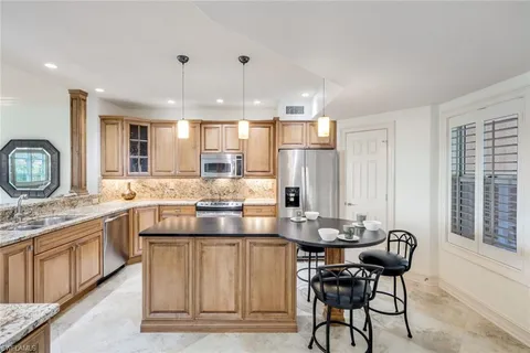 a kitchen with cabinets appliances and a counter