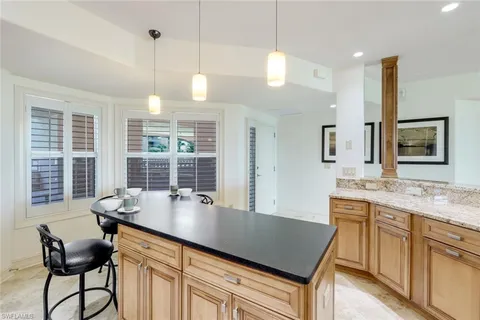 a kitchen with a table chairs sink and cabinets