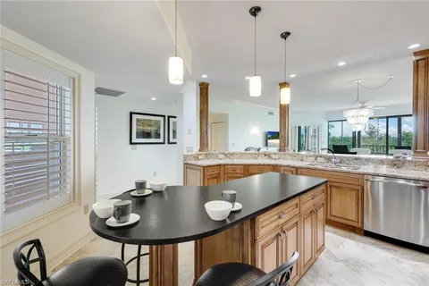 a kitchen with center island table and chairs in it