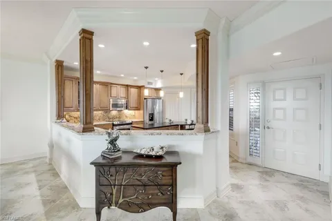 a kitchen with sink and refrigerator