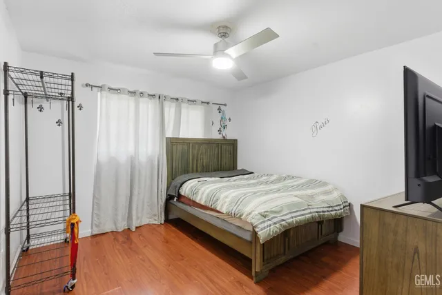 a bedroom with a bed table and a large mirror